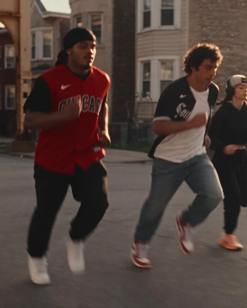Three fans running through Chicago at golden hour in the Rate x White Sox Pull Up campaign.