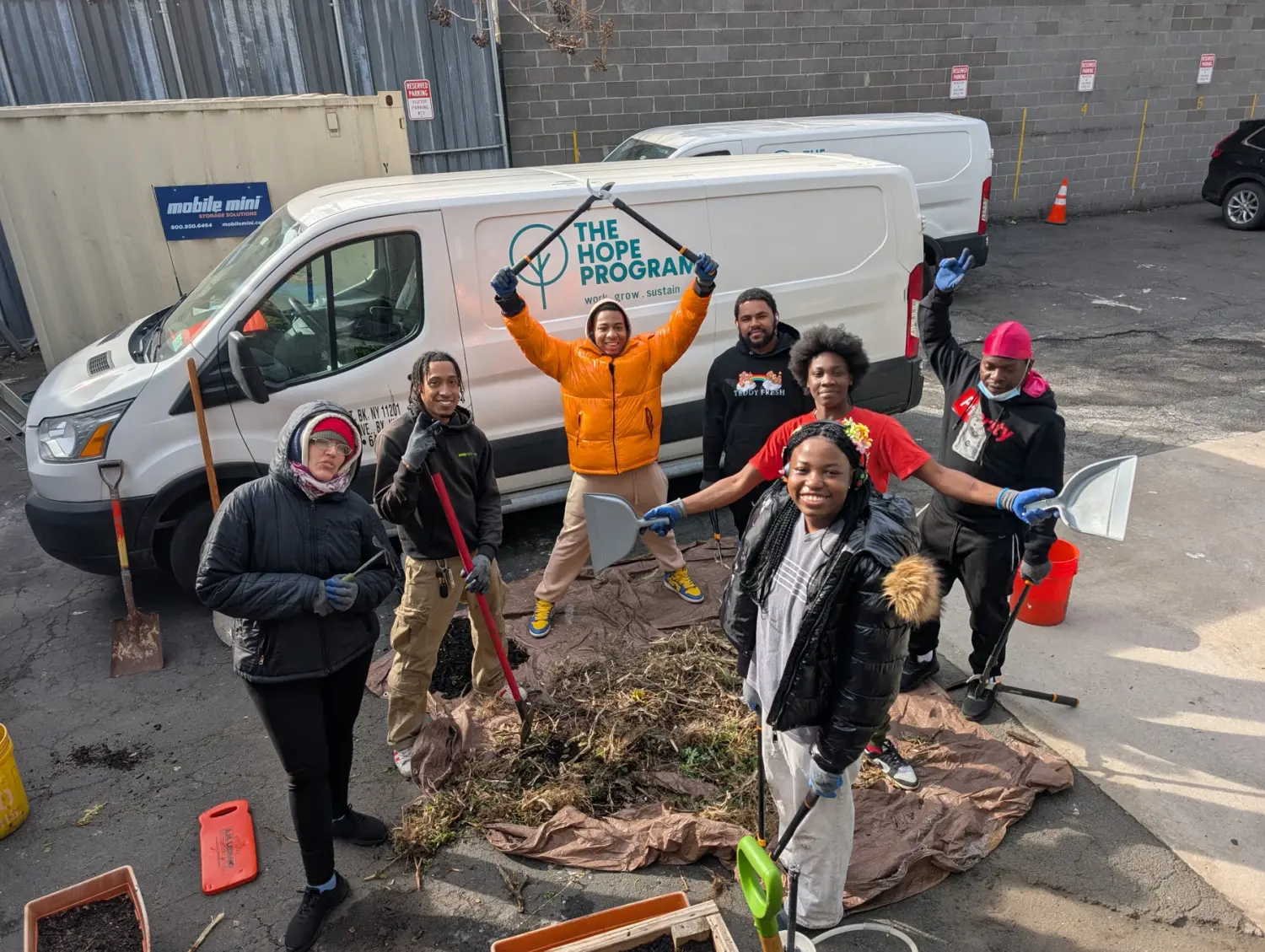 The HOPE Program community team beside a HOPE van in a supplied program photograph.