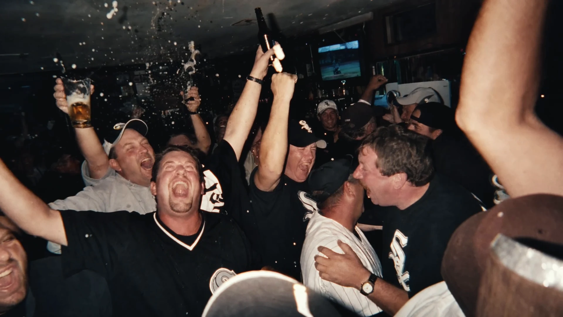 Fans celebrating together in the Rate x White Sox campaign.